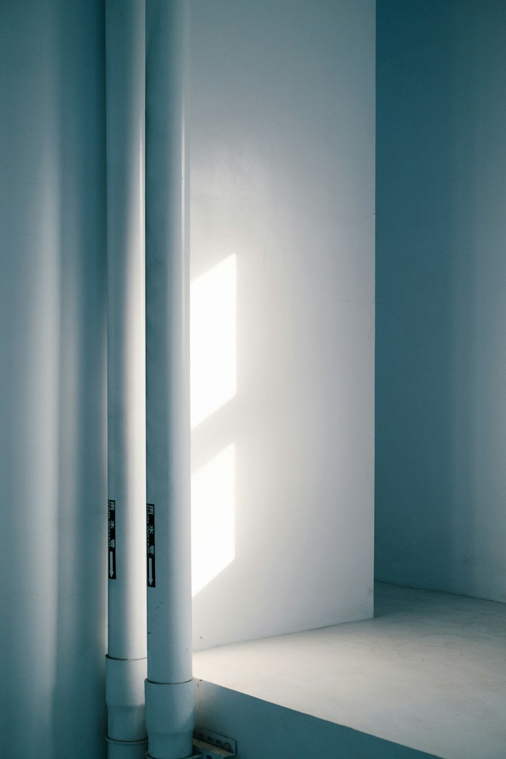 a white room with a light coming through the window