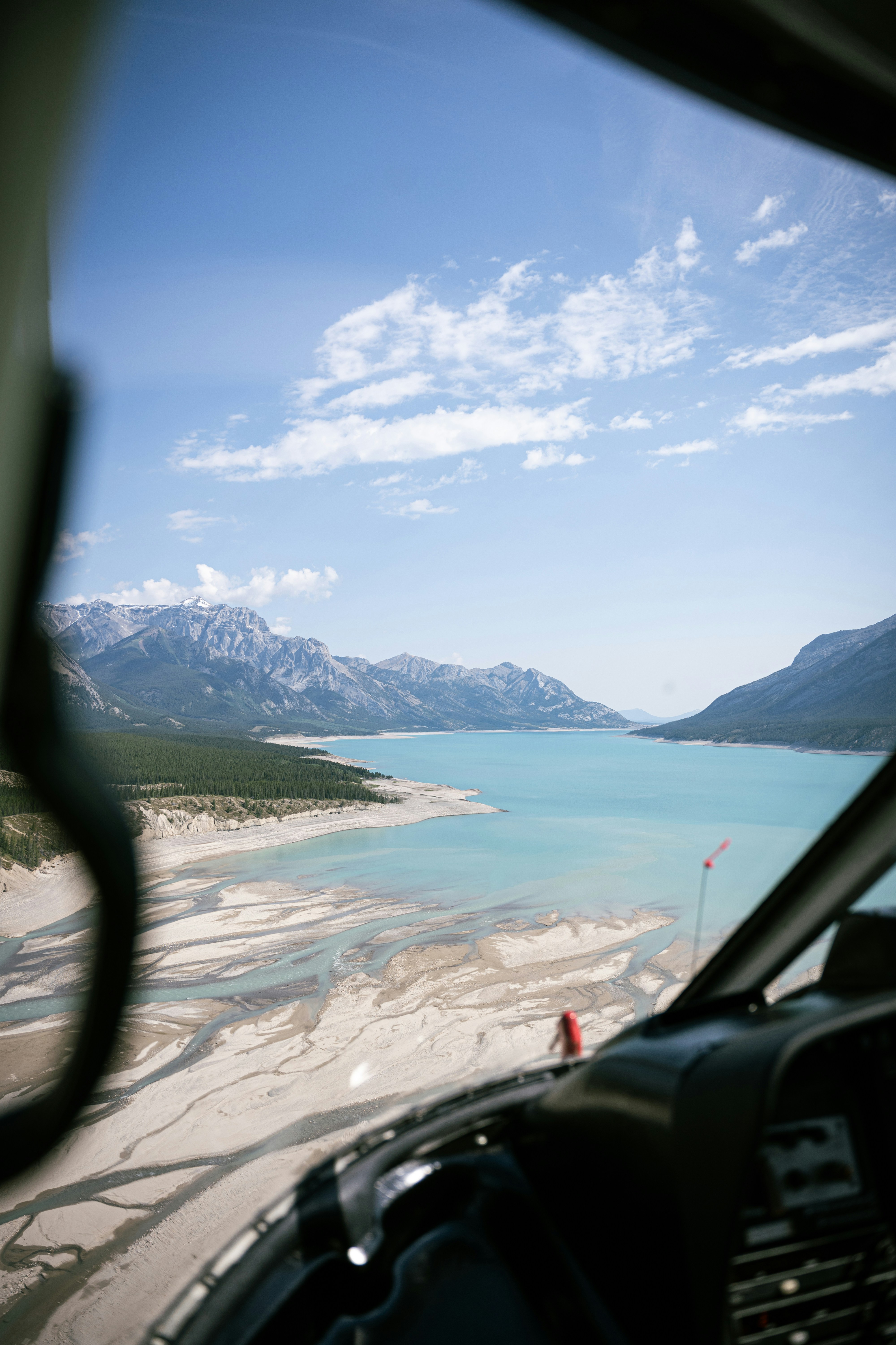 a view of a lake and mountains from inside a plane