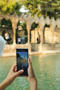 A travel vlogger capturing content in a beautiful location.