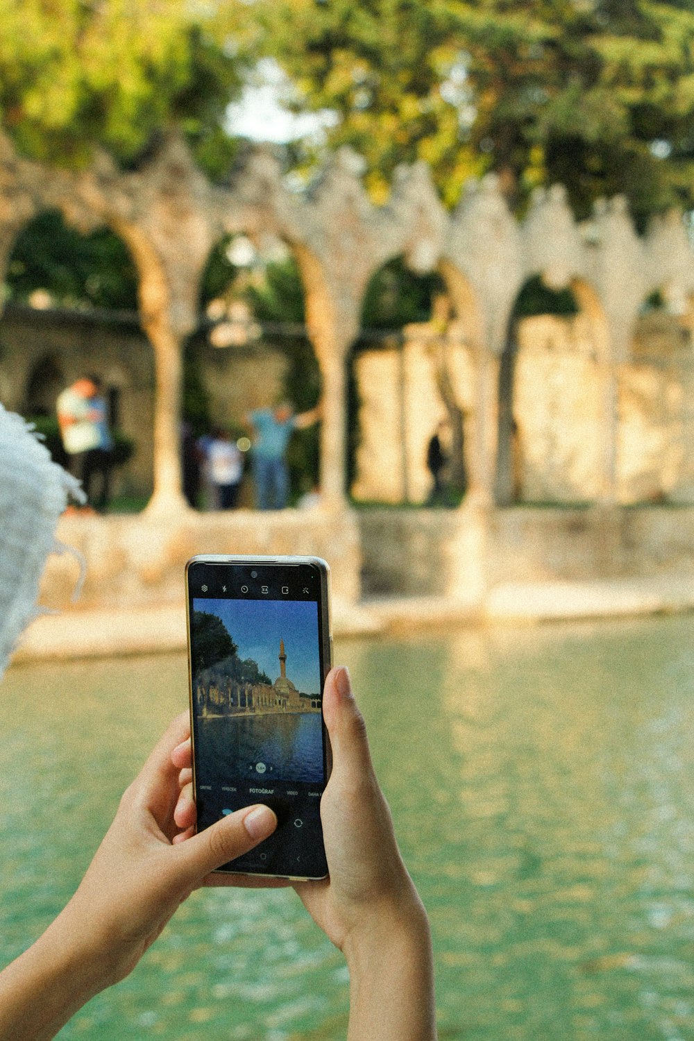 a person taking a picture of a building with a cell phone