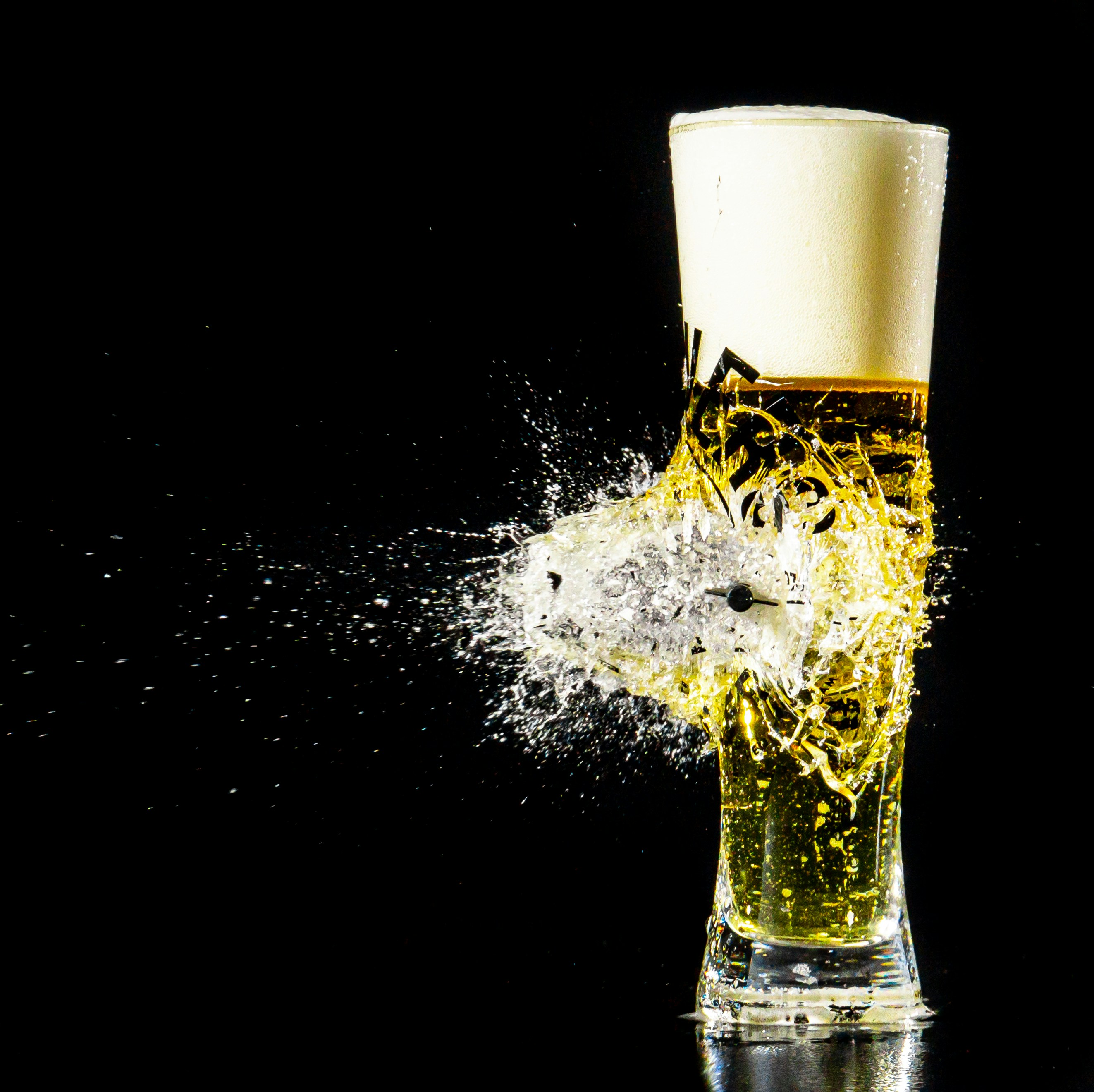 a glass of beer with a splash of water