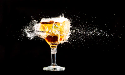 a glass filled with liquid on top of a table