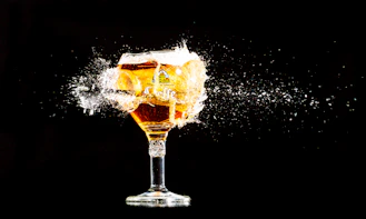 a glass filled with liquid on top of a table