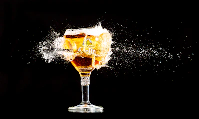 a glass filled with liquid on top of a table