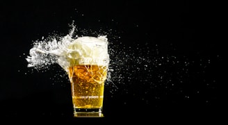 Close-up of a freshly poured amber craft beer with foam on top.