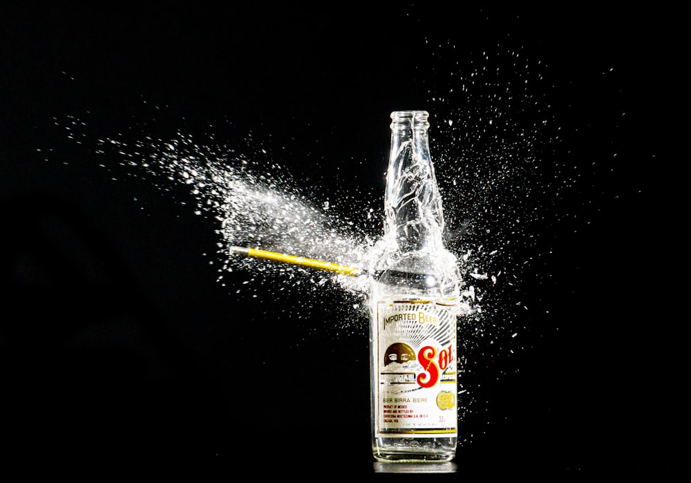 a bottle of alcohol is being splashed with water