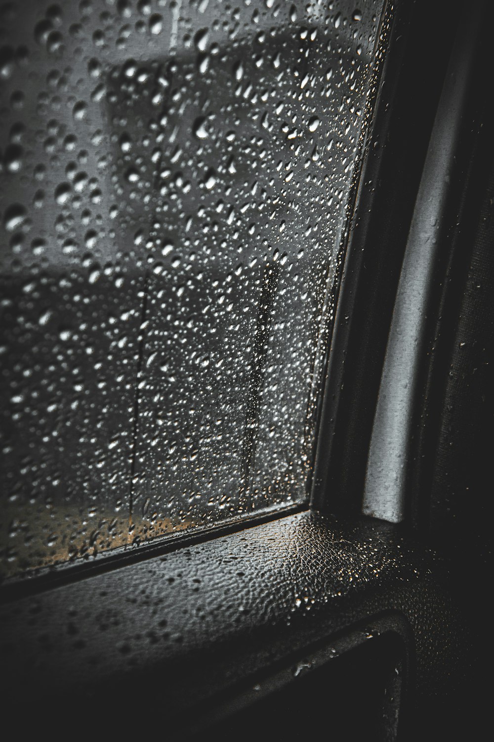 a close up of a car window with rain drops on it
