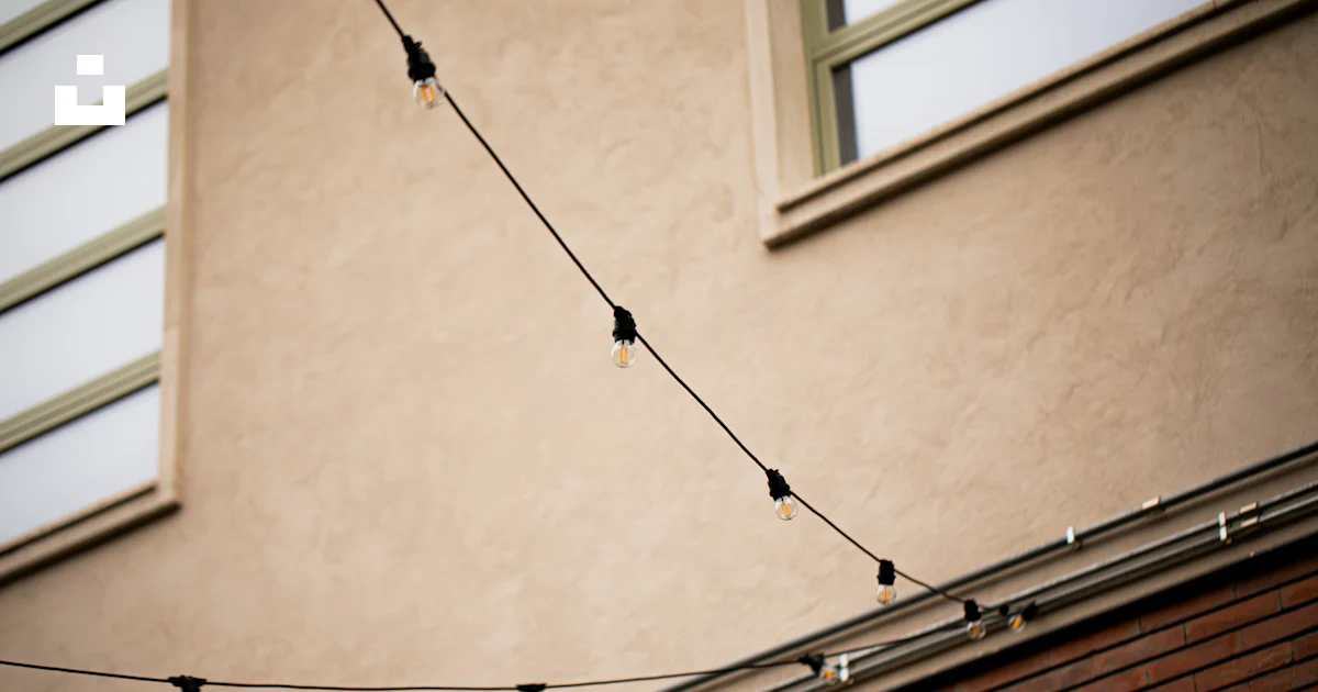 Building With String A building with a string of lights hanging from it's side photo – Free ...