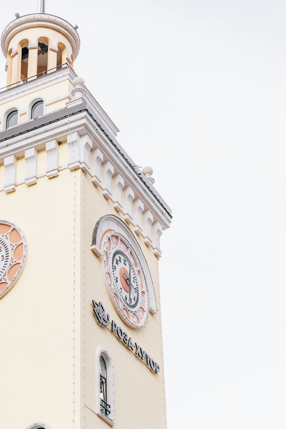 a tall clock tower with two clocks on each of it's sides