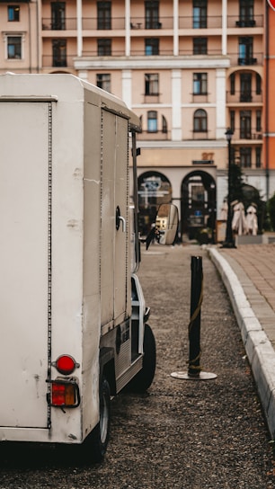 A delivery truck with the Marcos Winicius logo parked in a city street.