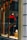 A storefront display features a mannequin dressed in a red and black ski outfit, complete with goggles and holding a snowboard. The scene is set against a snowy background with decorative logs and artificial snow, creating a winter sports theme.
