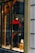 A storefront display features a mannequin dressed in a red and black ski outfit, complete with goggles and holding a snowboard. The scene is set against a snowy background with decorative logs and artificial snow, creating a winter sports theme.