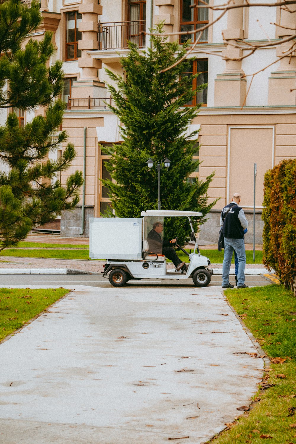 a man standing next to a white golf cart