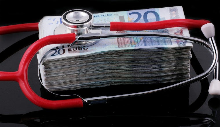 Stethoscope resting on a stack of money, representing healthcare accounts receivable and revenue recovery