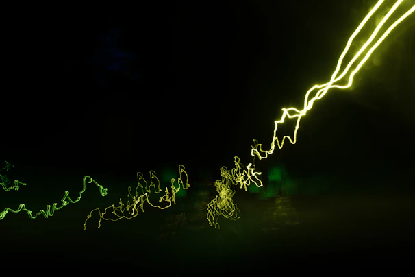 Vibrant neon green and orange light particles forming a dynamic DNA helix twisting gracefully on the right side of the frame.