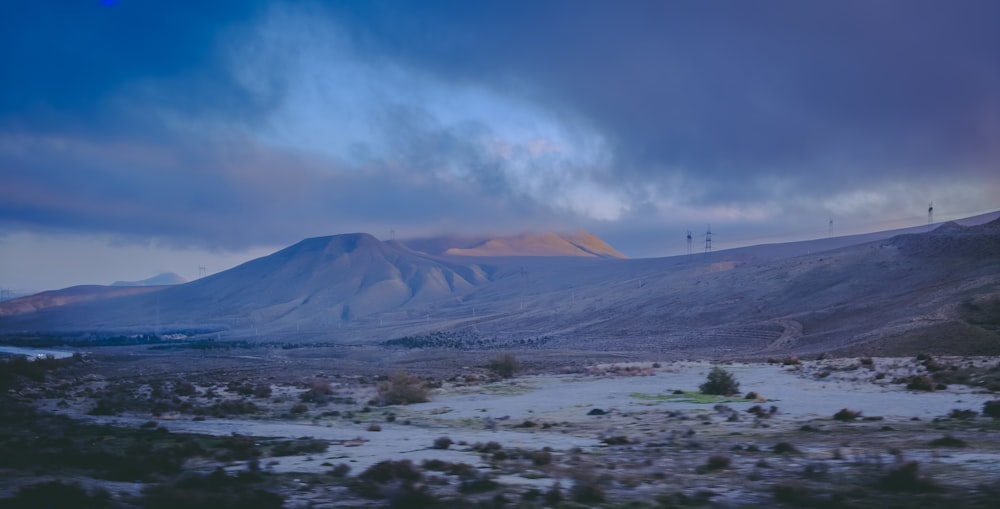 a view of a mountain with a cloudy sky