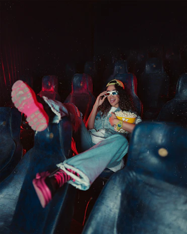 Festival-goers laughing and sharing popcorn inside a cozy screening room.