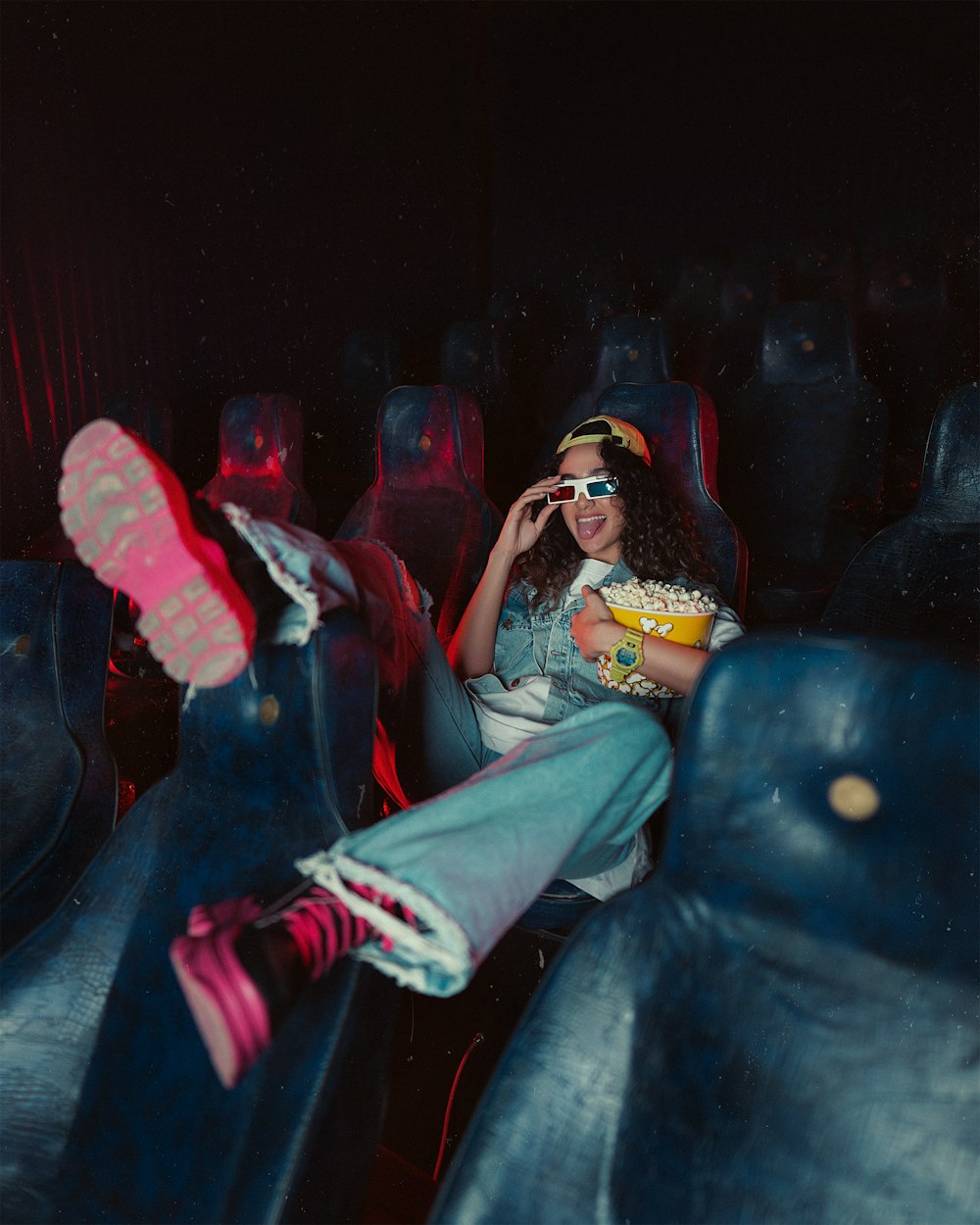 a woman sitting in the middle of a movie theater