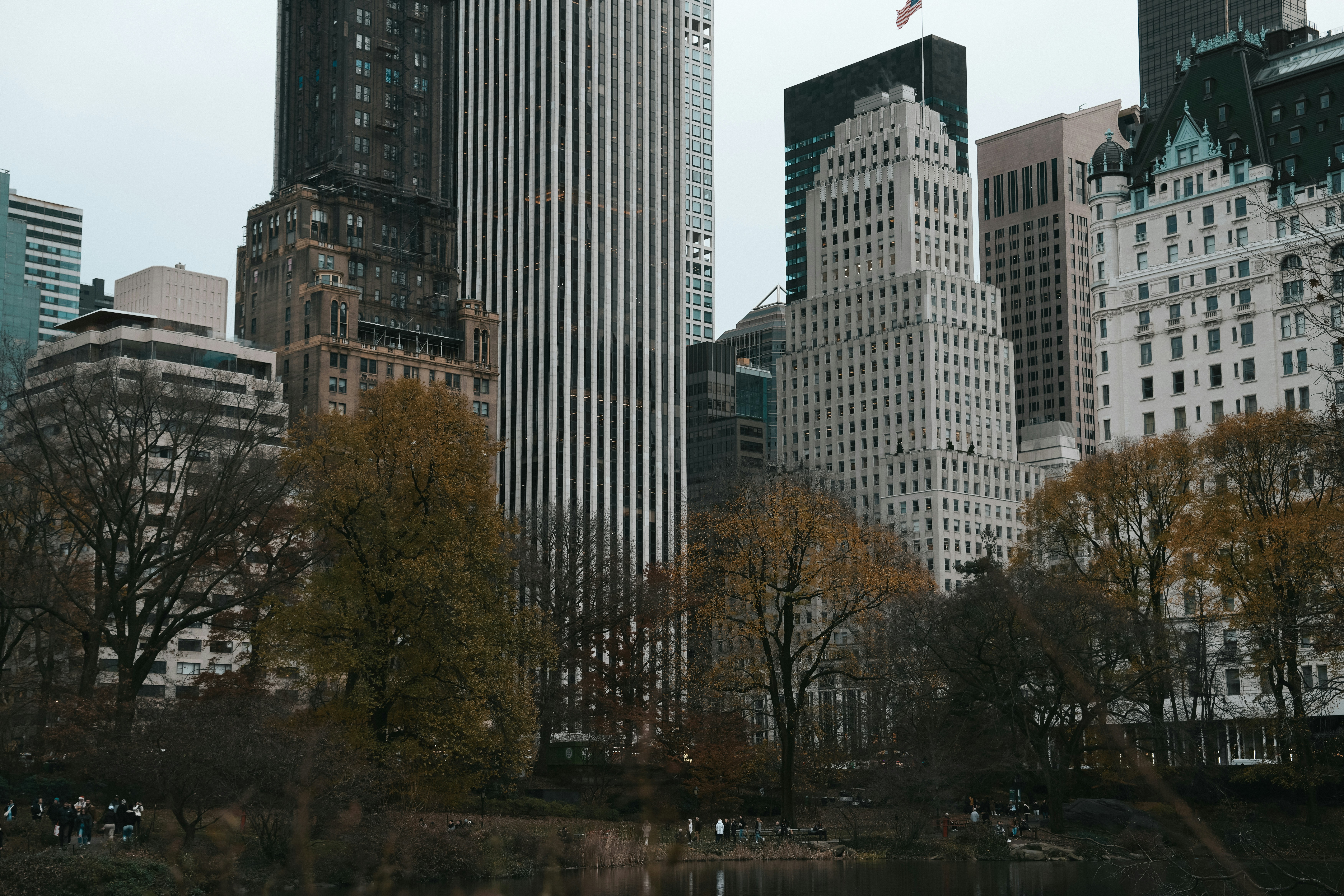 a group of tall buildings next to a body of water