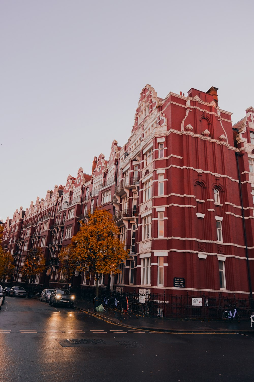 a very tall red building sitting on the side of a road