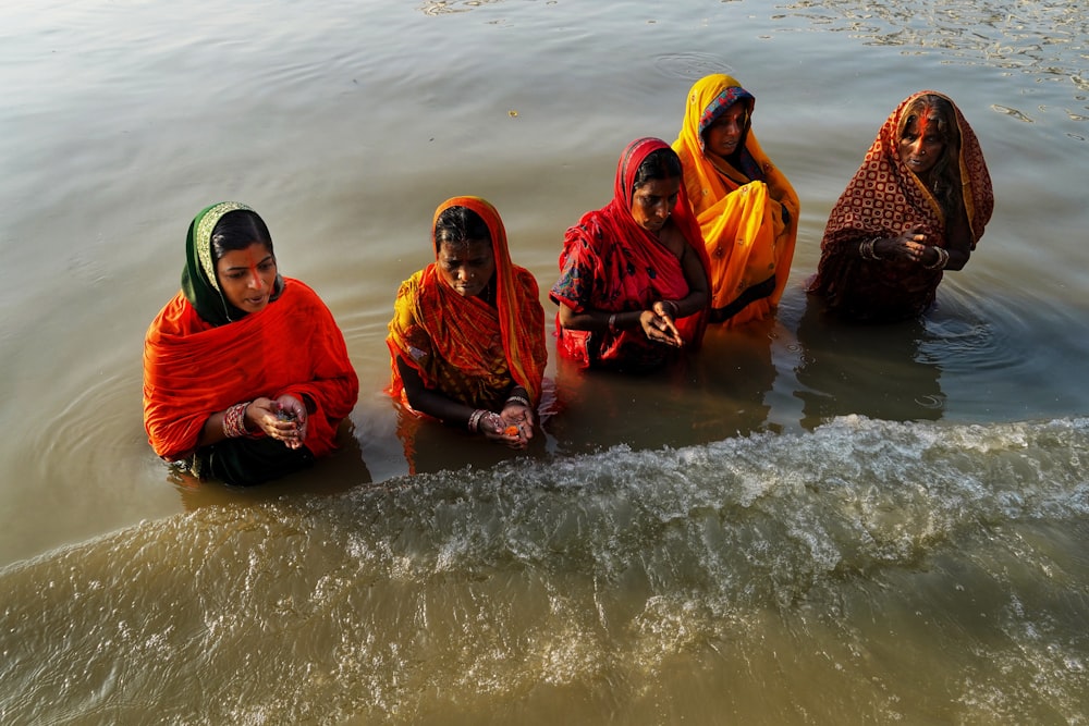 a group of women sitting in the water