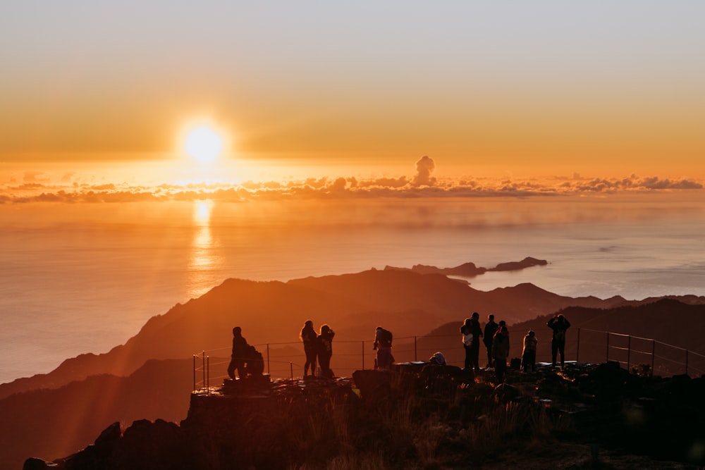 a group of people standing on top of a mountain