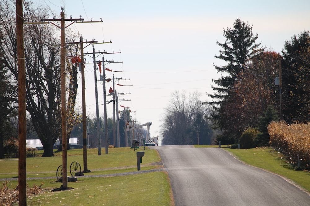 an empty street with power lines and telephone poles