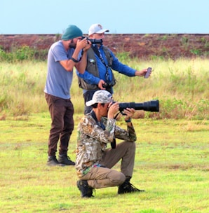 A team of photographers working together at an outdoor event.