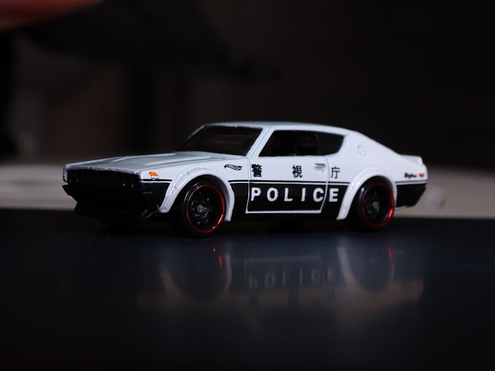 a toy police car sitting on top of a table