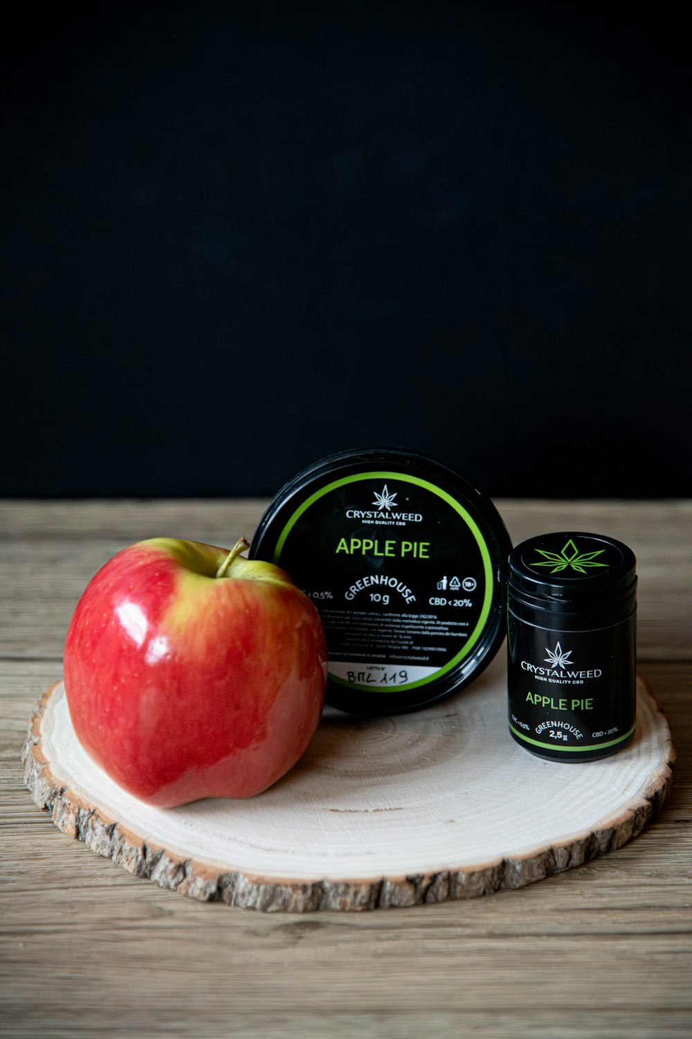 a red apple sitting on top of a wooden table