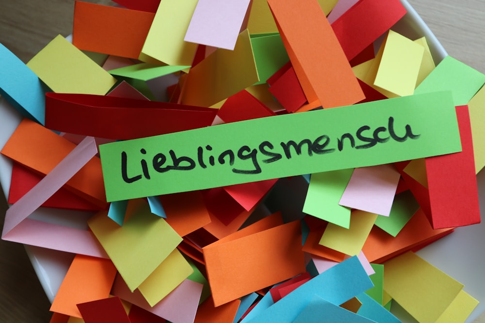 a pile of colorful pieces of paper with the word libings mescu