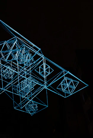 A large-scale art installation featuring suspended geometric forms casting playful shadows.