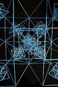 Abstract geometric mesh in deep steel blue shades, representing encrypted data flow.