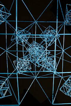 A sleek wireframe 3D model glowing in cobalt blue, representing digital transformation.