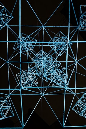 Sleek architectural blueprint overlaying a glowing digital network on a dark space-blue background.
