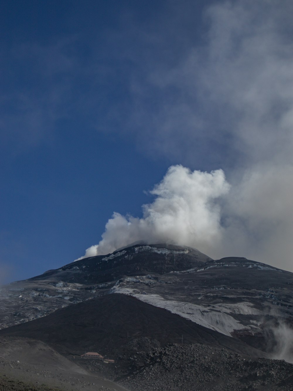 a mountain with a cloud of smoke coming out of it