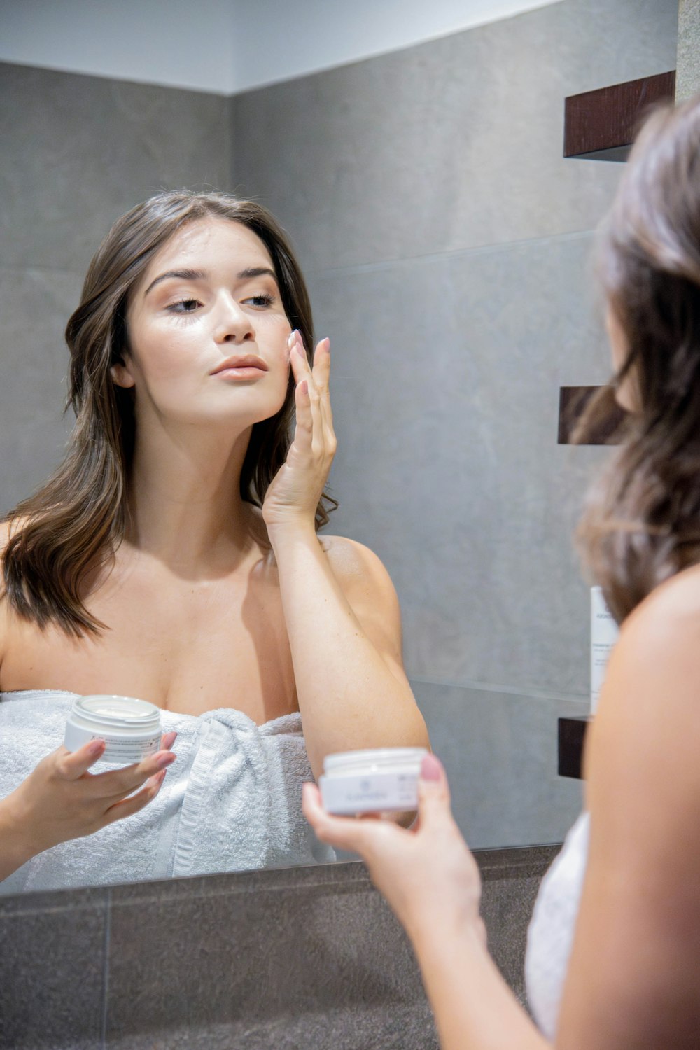 a woman is looking at her reflection in the mirror