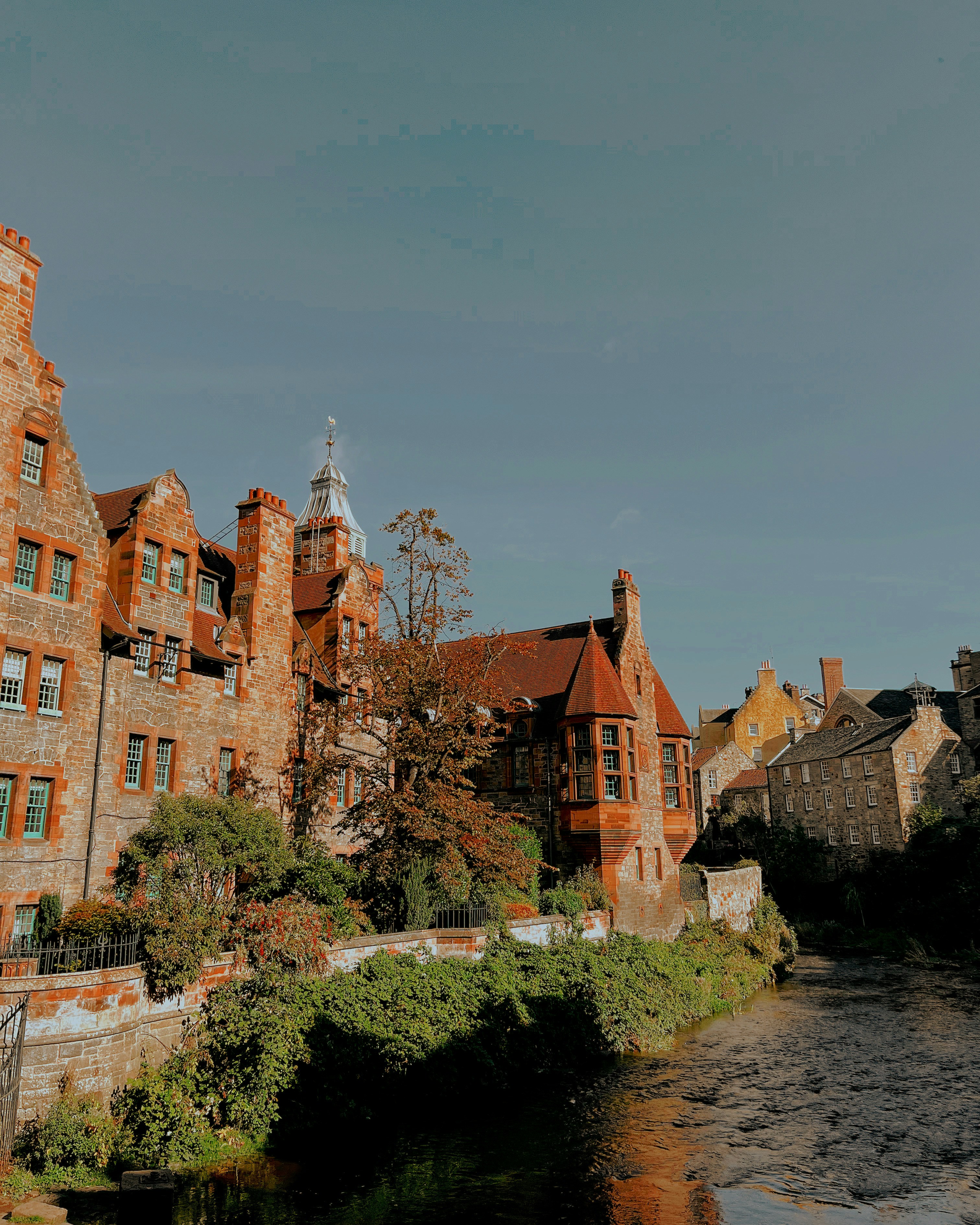 a river running through a city next to tall buildings