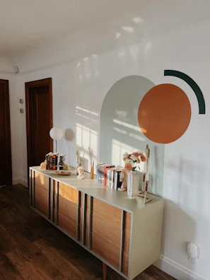 Stylish sideboard buffet against a textured wall with ambient lighting.
