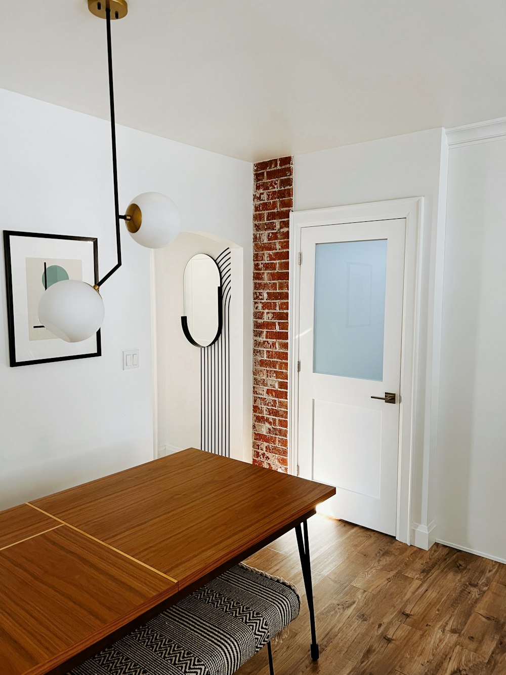 a room with a wooden table and a brick wall