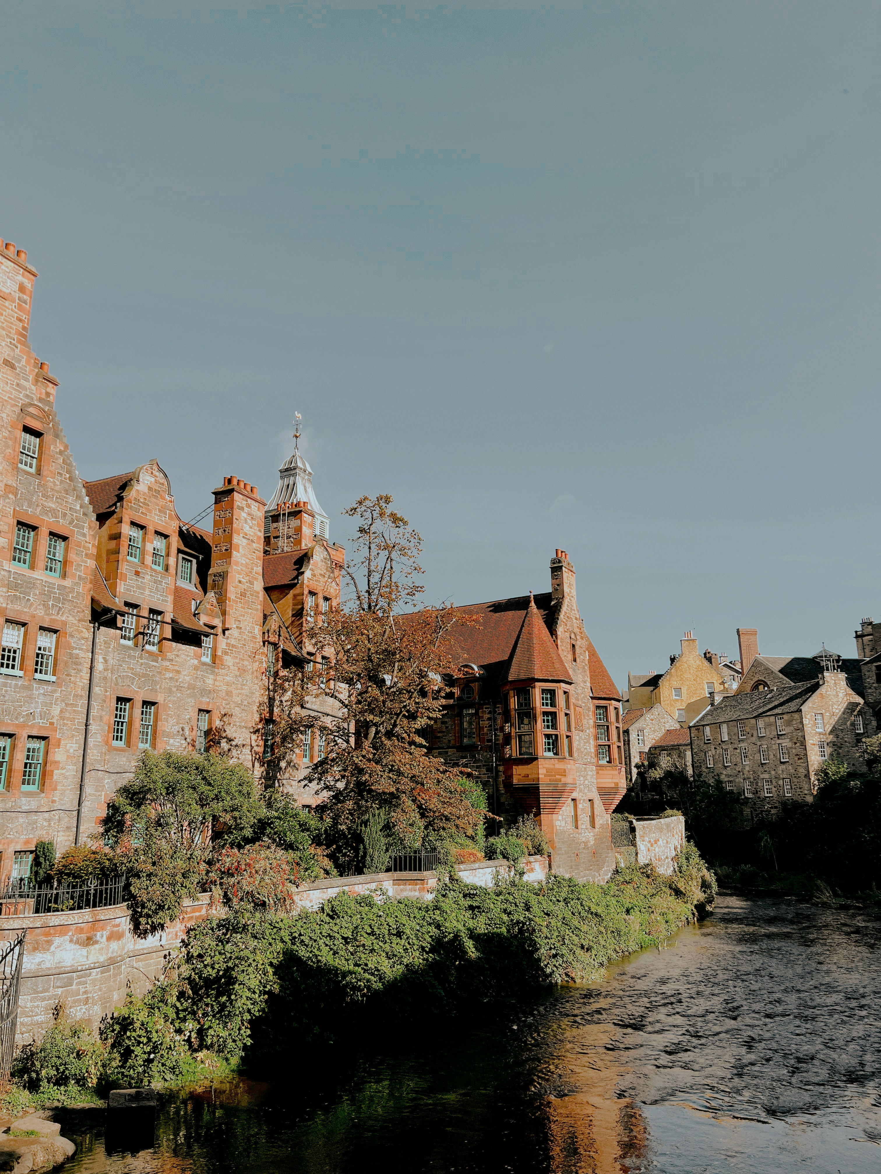 a river running through a city next to tall buildings