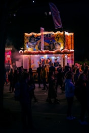 A lively festival scene with the Kartoffelschlösschen food truck serving crispy potato spirals to happy customers.