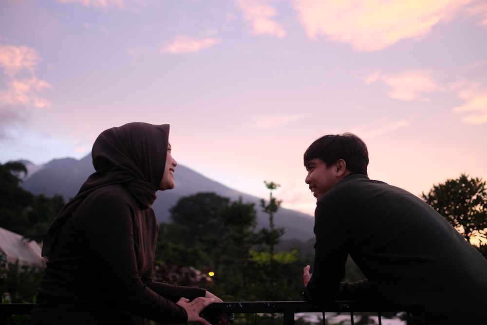 a man and a woman sitting on a bench