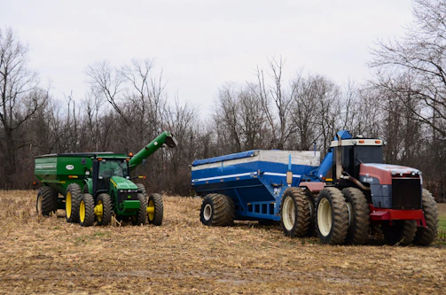 A sturdy Fotrak China tractor parked beside a freshly harvested cornfield, ready for the next task.