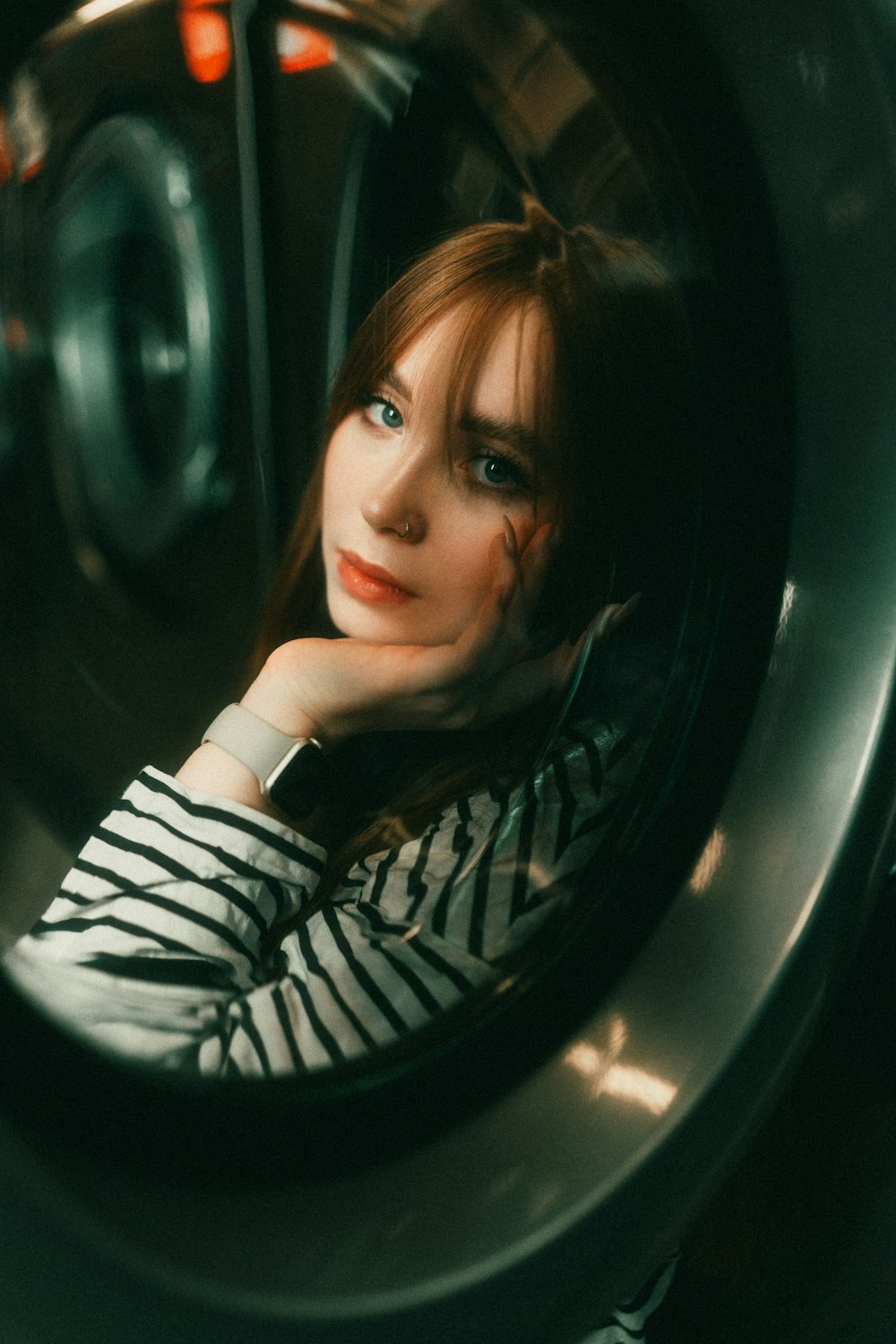 a woman sitting in front of a washing machine