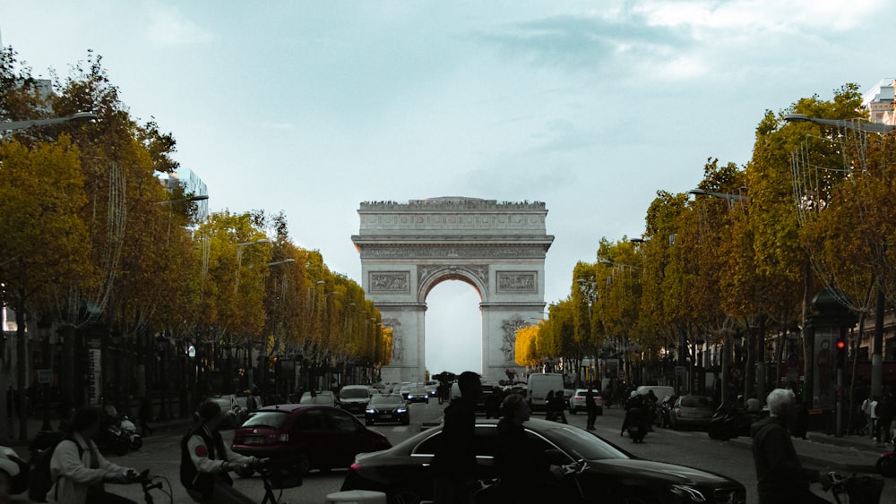 a busy city street with cars, motorcycles and pedestrians