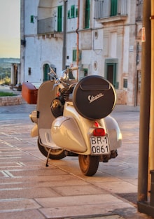 a motor scooter parked on the side of the road