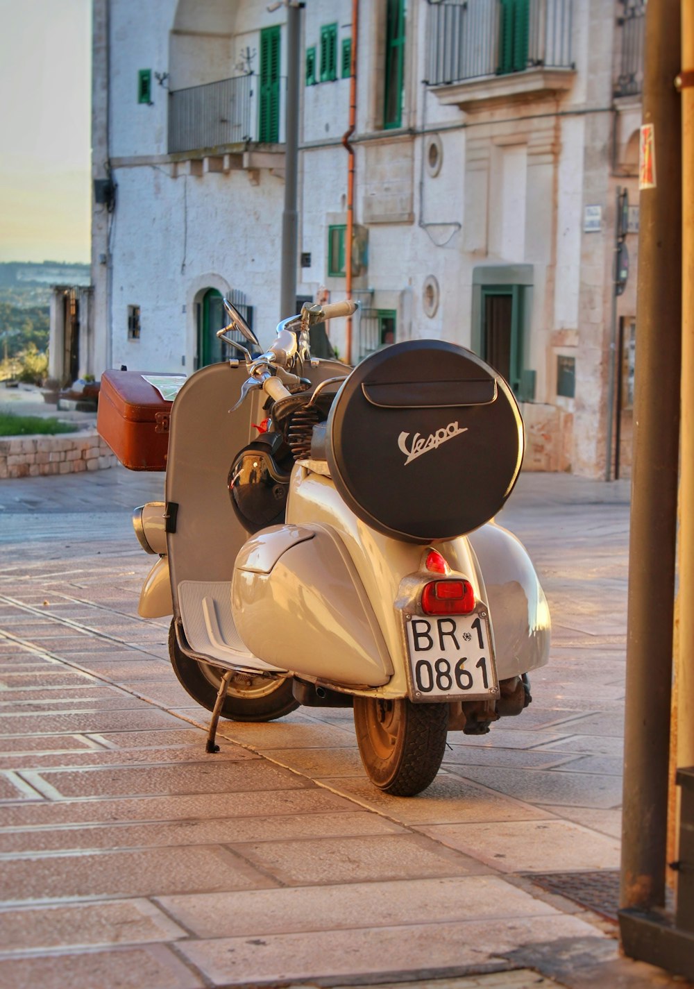 a motor scooter parked on the side of the road