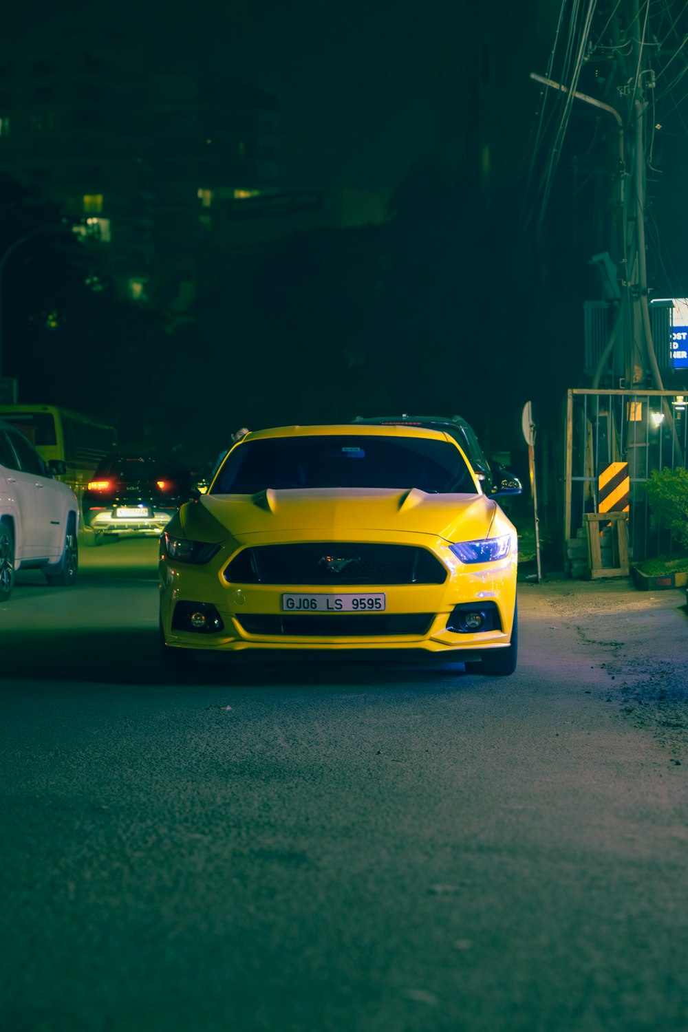 a yellow car parked on the side of the road