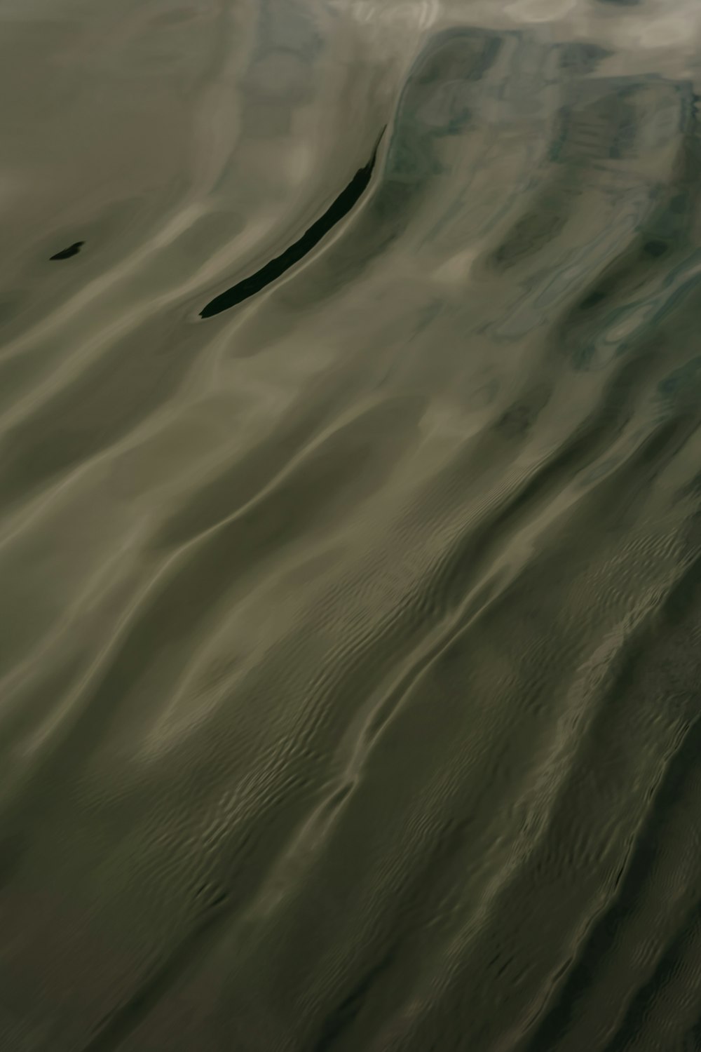 a large body of water with a sky in the background